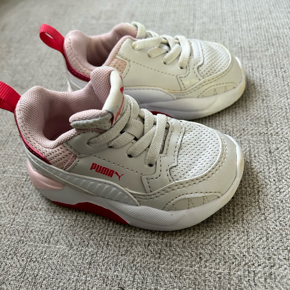 Gray with pink and white accented girls Puma sneaker. Size 4.